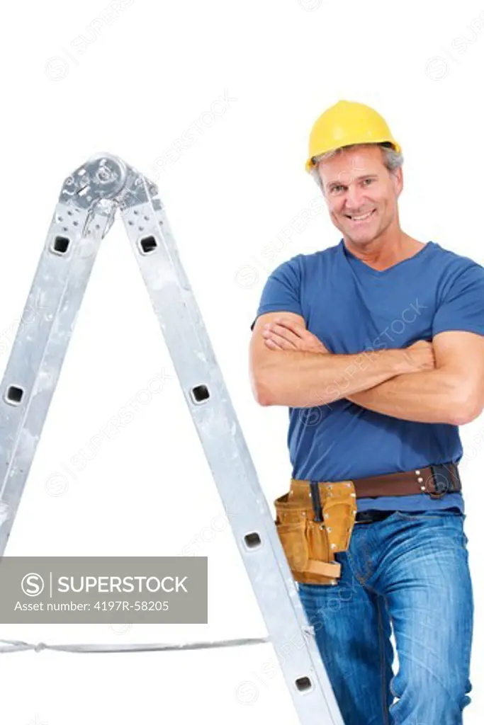 A handsome contractor crossing his arms while standing beside a ladder - Isolated