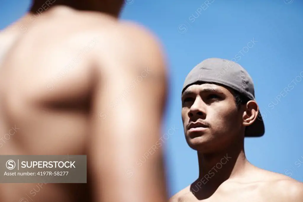 Cropped image of two men looking at one another outside