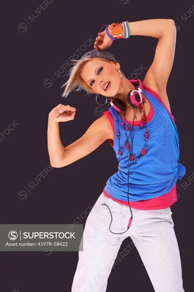 Trendy young girl in urban attire dancing against a background of colored lights - digitally manipulated