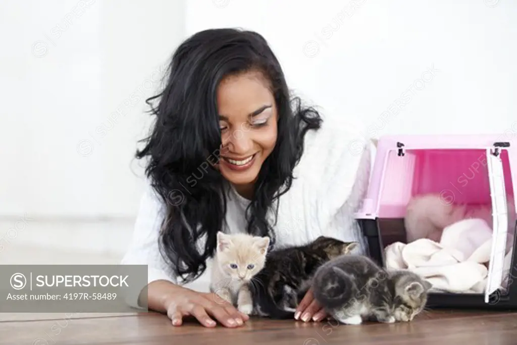 Attractive young woman woman opening a carry-case to let out some little kittens