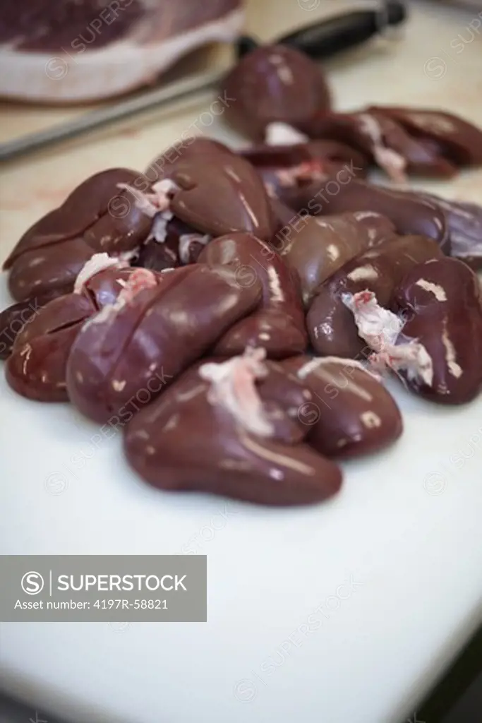 Closeup image of a plate with raw kidneys - copyspace
