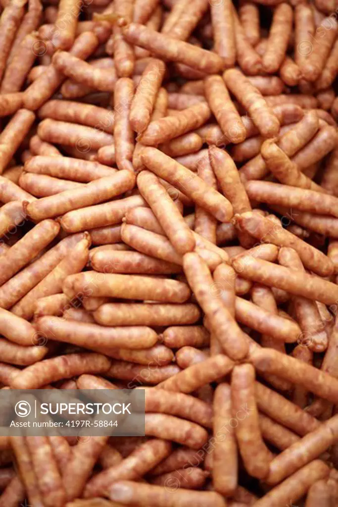 Closeup image of a pile of raw sausages - cropped
