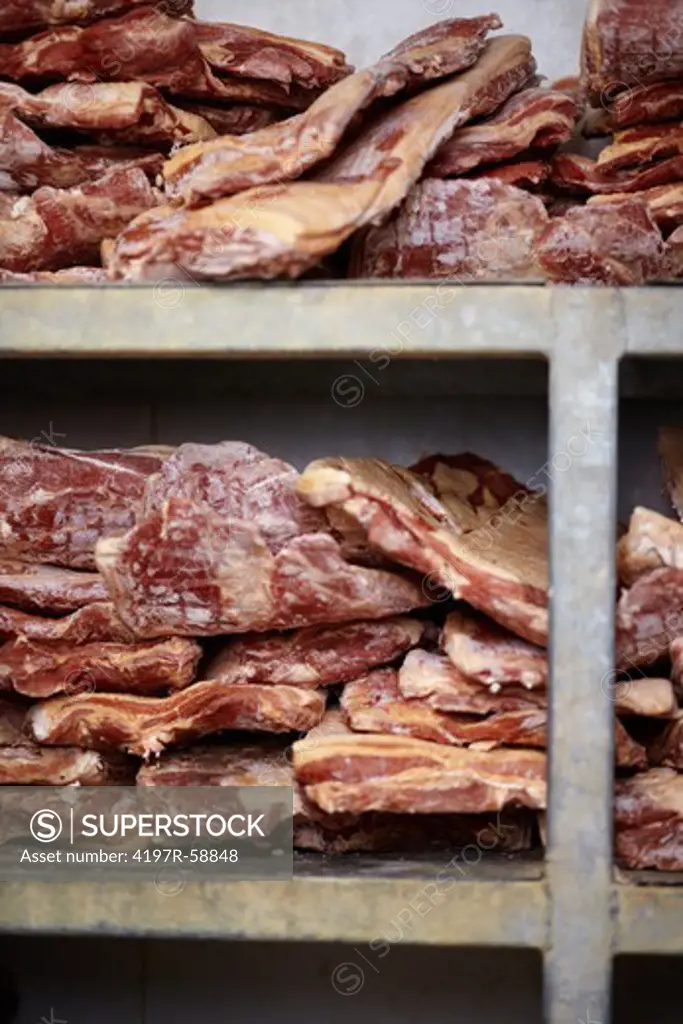 Stacks of raw meat cut in a cool storage facility - closeup