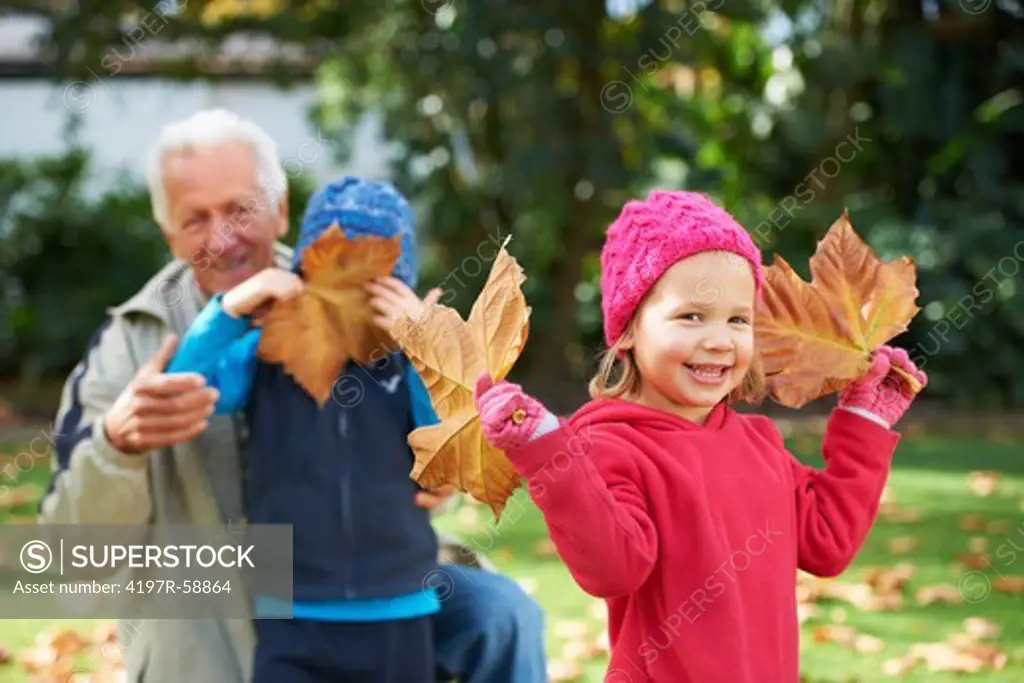 Portrait of a grandfather outside with his grandchildren