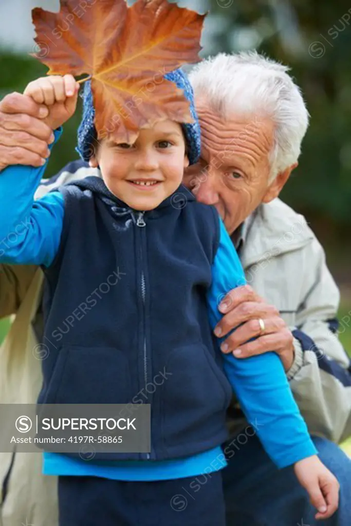 Portrait of a grandfather outside with his grandson