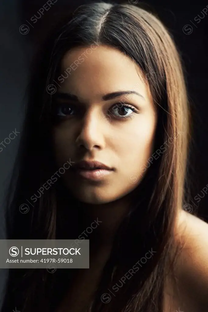 Close up of a naturally gorgeous Latina woman gazing candidly at the camera