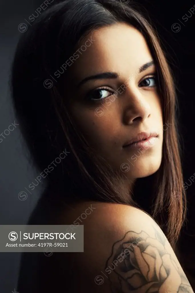 Sensual latina woman gazing over her shoulder at the camera