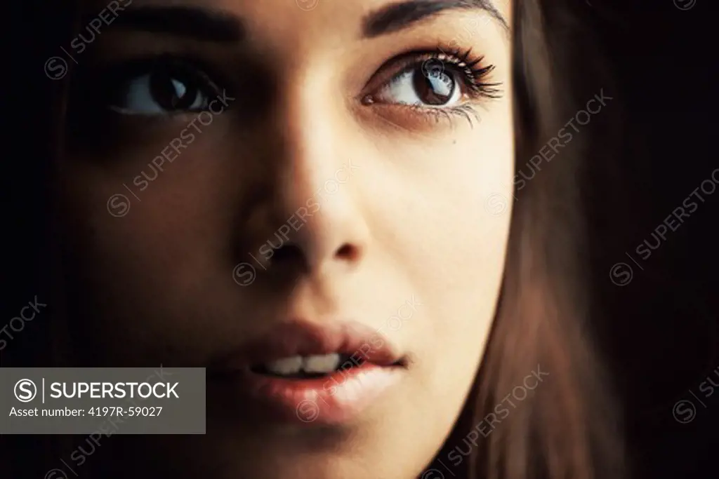 Cropped close up of a naturally gorgeous young hispanic woman gazing upwards