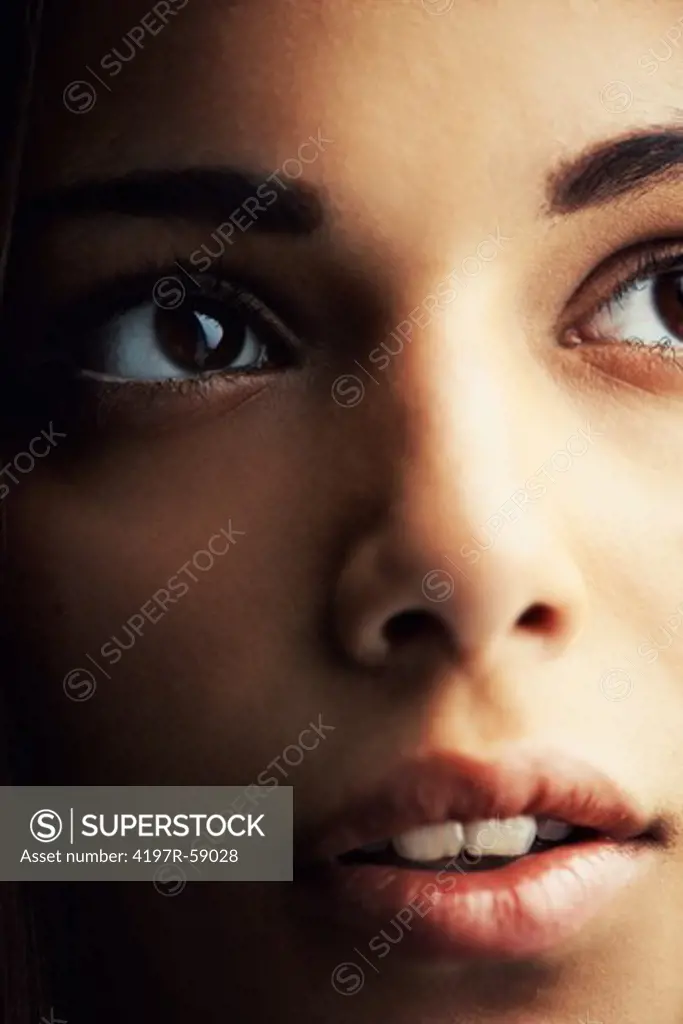 Cropped close up of a naturally gorgeous young hispanic woman gazing upward