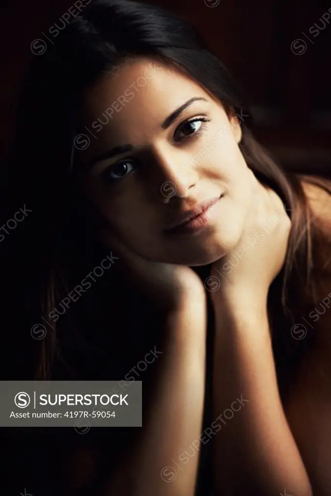 Stunning young hispanic woman gazing warmly at the camera with a gentle smile