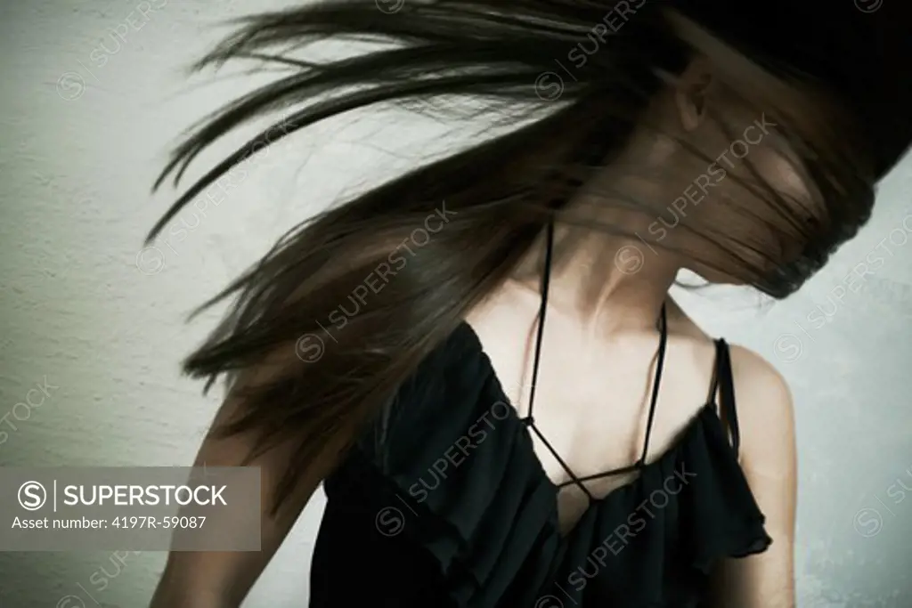A woman's head flying back having been struck, her hair covering her face