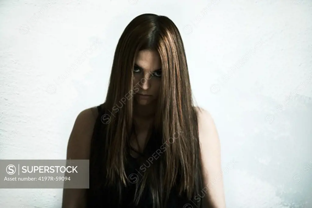 Portrait of a young woman staring creepily at you with a blank expression