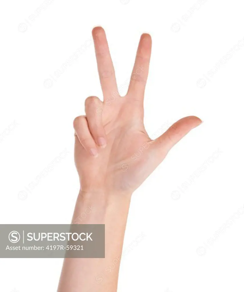 Cropped view of a hand indicating the number three with its fingers