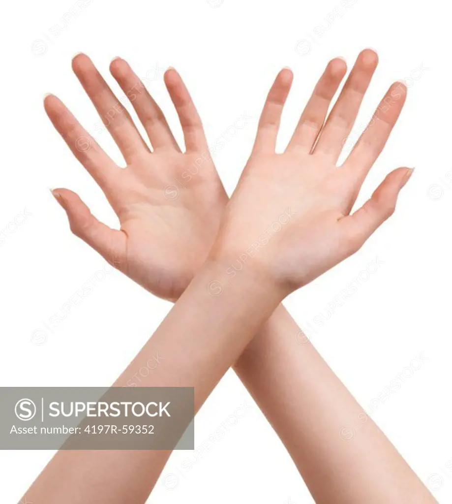 Cropped view of hands crossed at the wrists against a white background