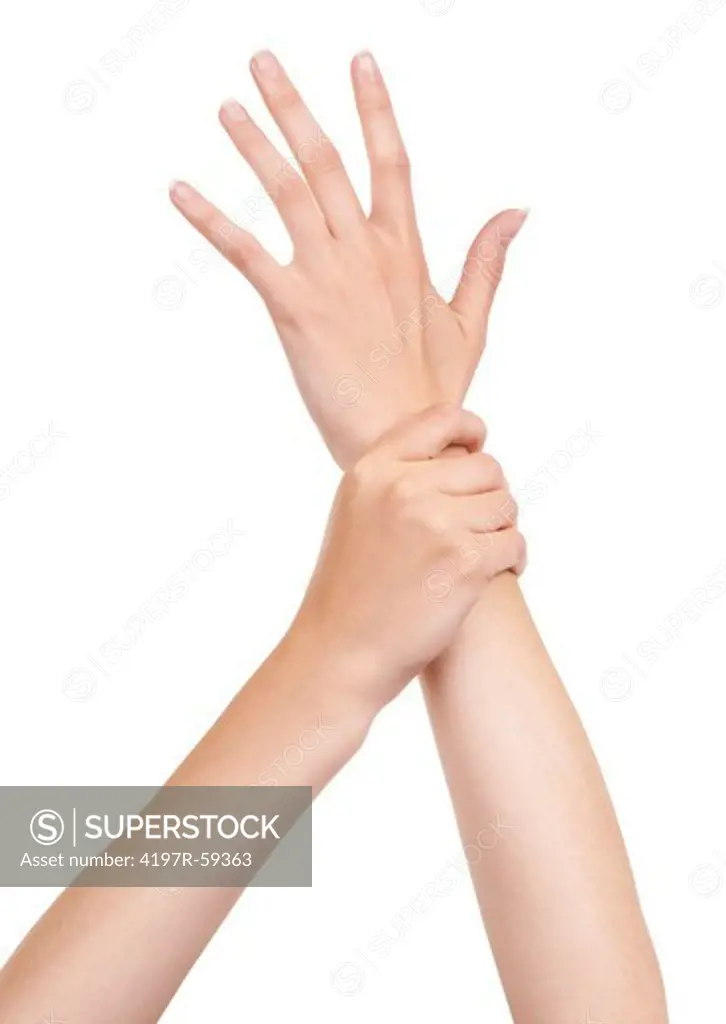 Cropped view of an open palm hand being held back by another hand at the wrist