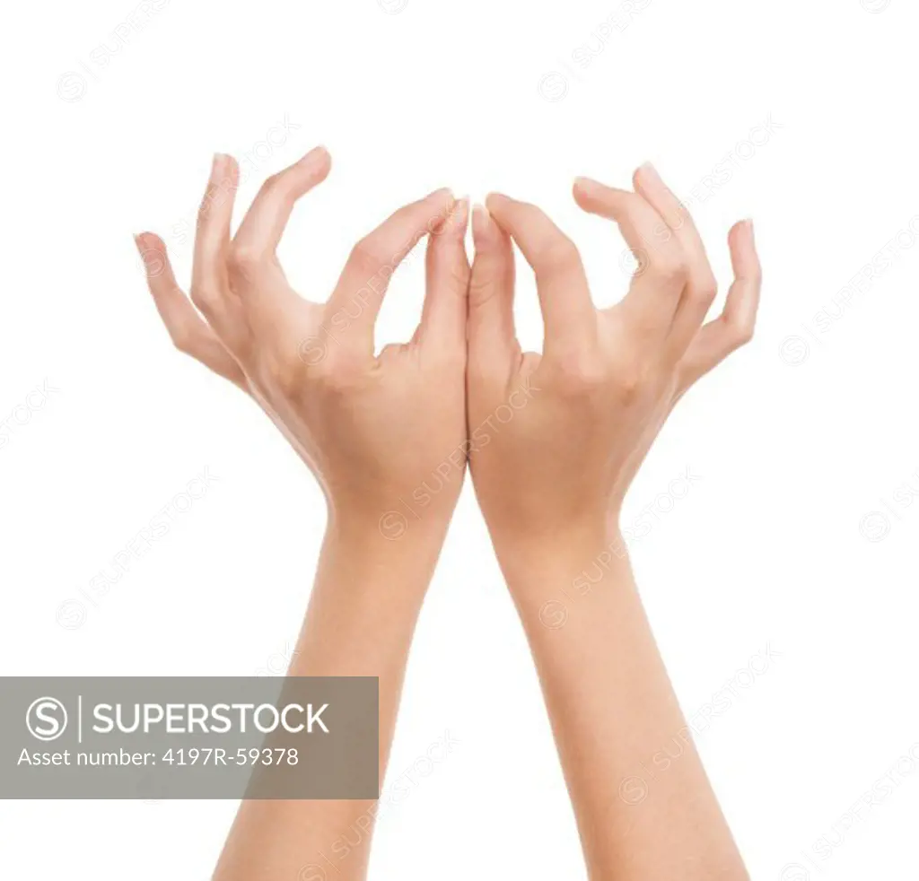 Cropped view of hands with fingertips poised to hold something very delicate and small