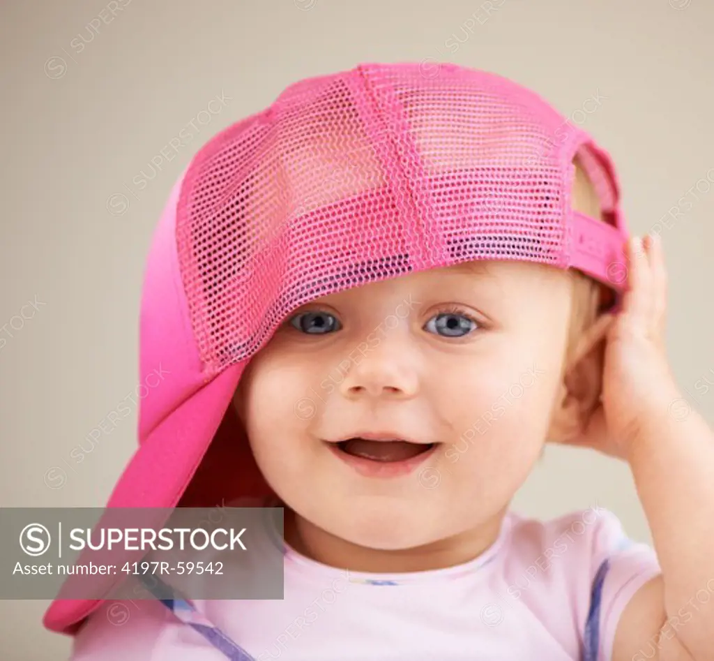 A cute little girl wearing an oversized hat