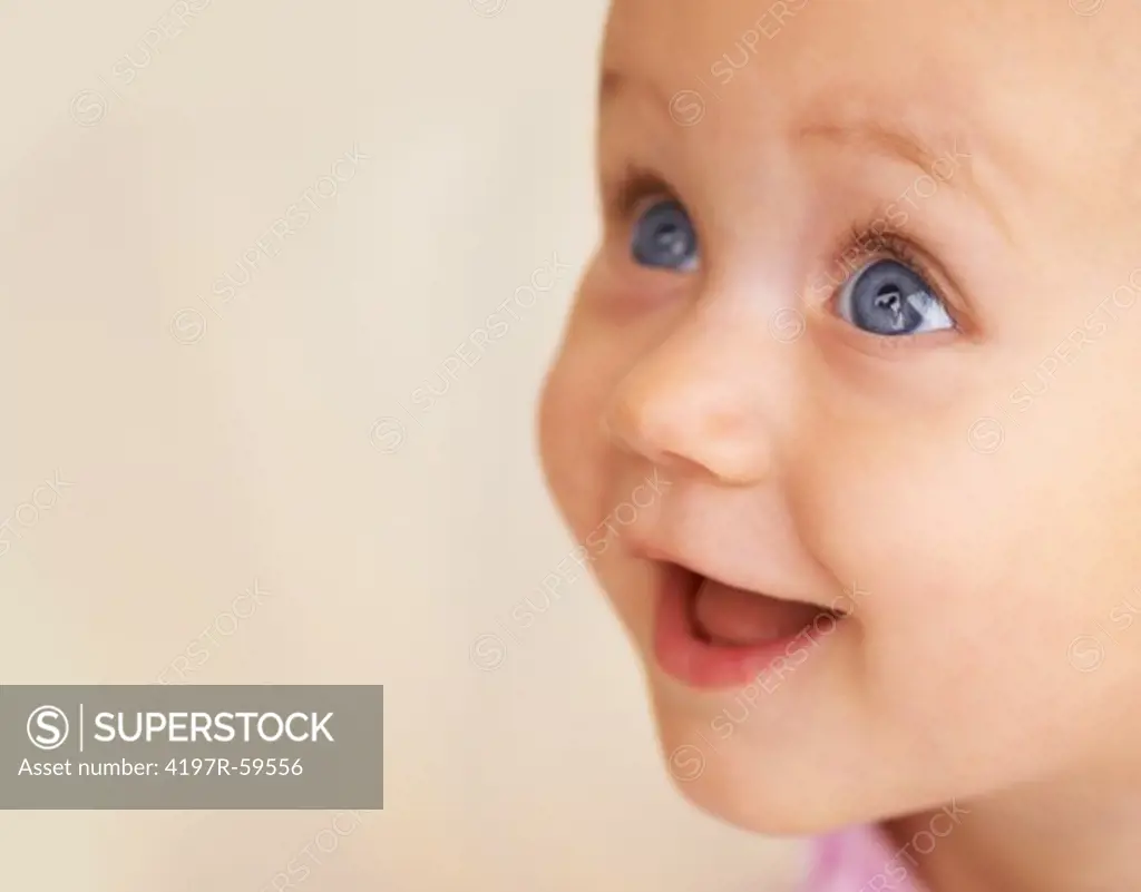 An adorable baby girl looking up