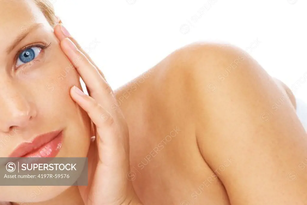 Portrait of an attractive young woman touching her cheek on a white background