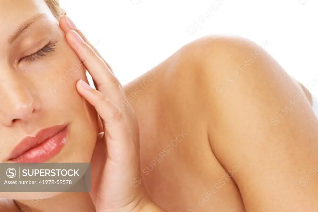 A pretty young woman with her eyes closed on a white background