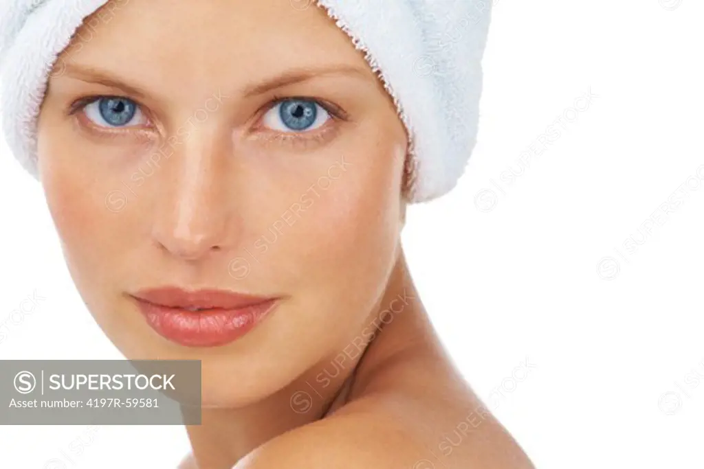 Portrait of a beautiful young woman with a towel on her head on a white background