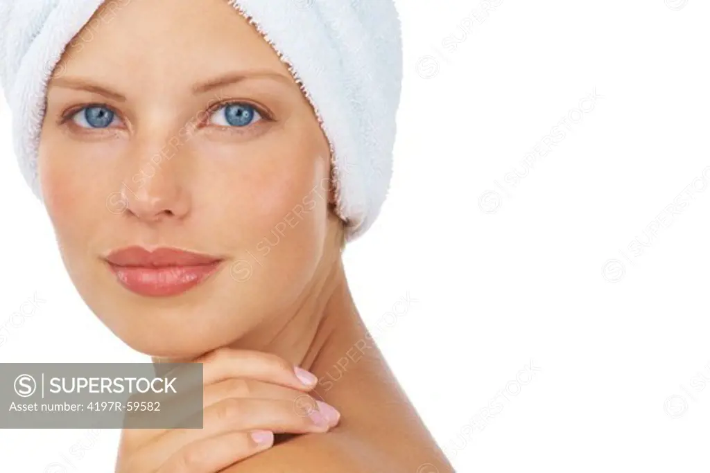 Portrait of a pretty young woman with a towel on her head on a white background