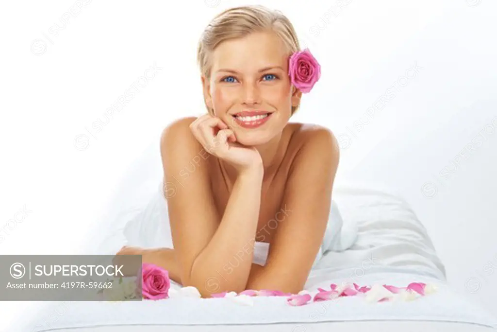 Portrait of an attractive young woman lying in a spa on a white background