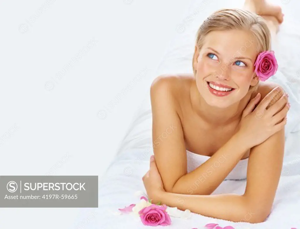 An attractive young woman relaxing in a spa on a white background