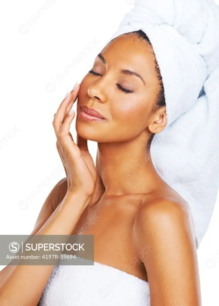 A beautiful african american woman enjoying the feel of her smooth skin after a spa treatment