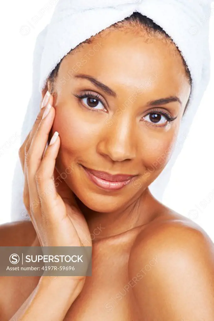 A beautiful african american woman enjoying the feel of her smooth skin after a spa treatment