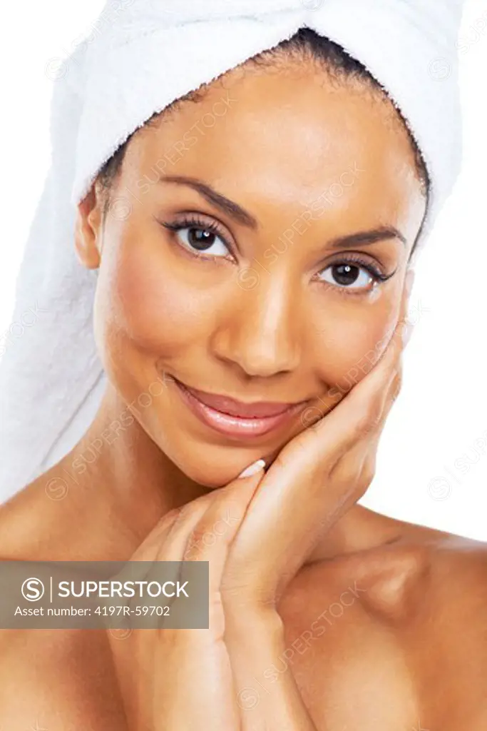 A beautiful african american woman feeling her smooth skin after a refreshing spa treatment