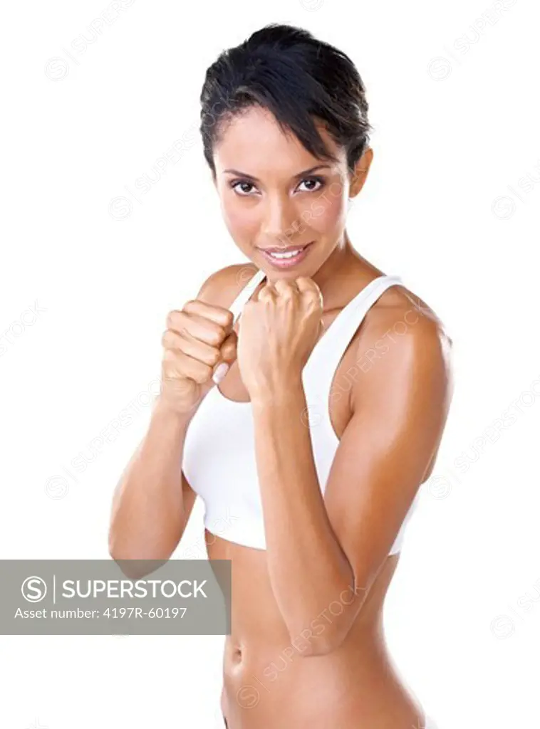 Beautiful young woman with her fists raised against a white background in a fighter's stance