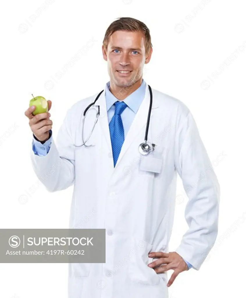 Studio shot of a handsome young doctor holding up an apple with a bite taken from it isolated on white