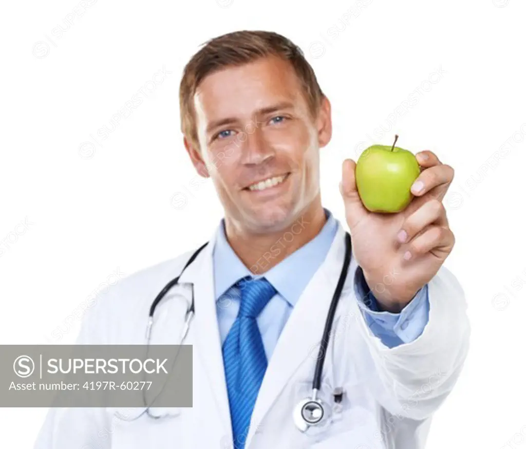 Studio shot of a handsome young doctor holding a green apple up to the camera isolated on white