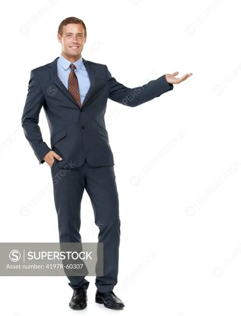 A handsome young businessman motioning towards copyspace while isolated on white