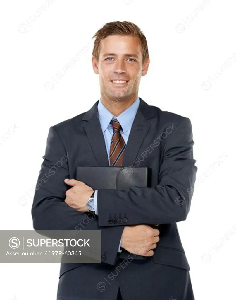 A handsome executive holding a leather binder containing his business ideas close to his chest