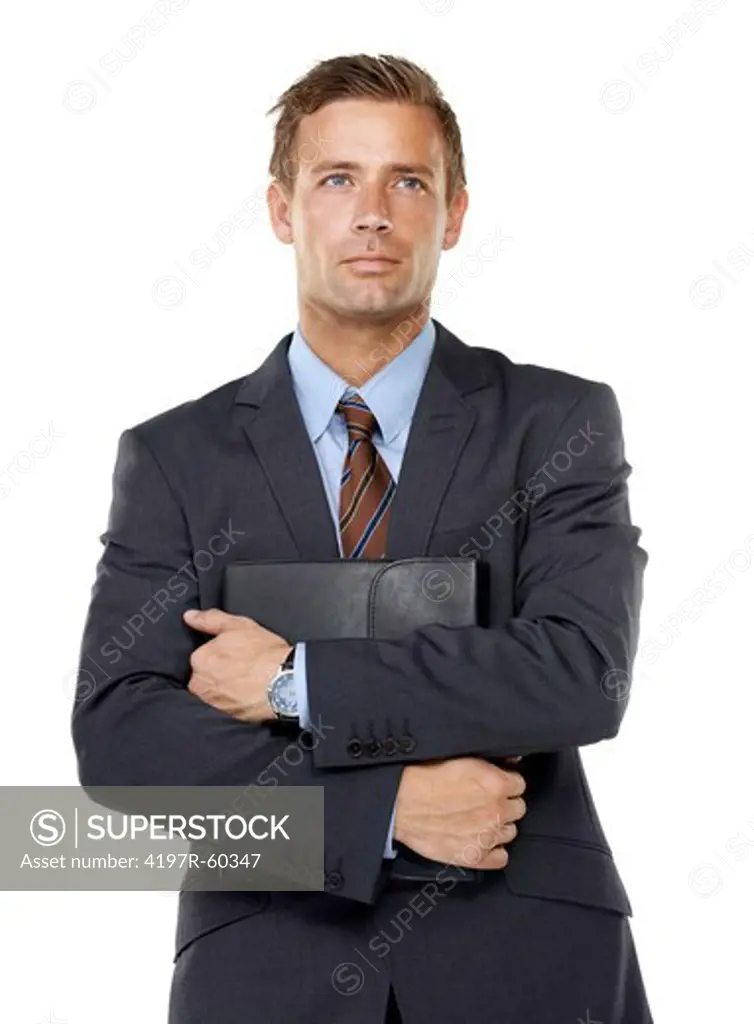 An ambitious executive holding a leather binder containing his business ideas close to his chest