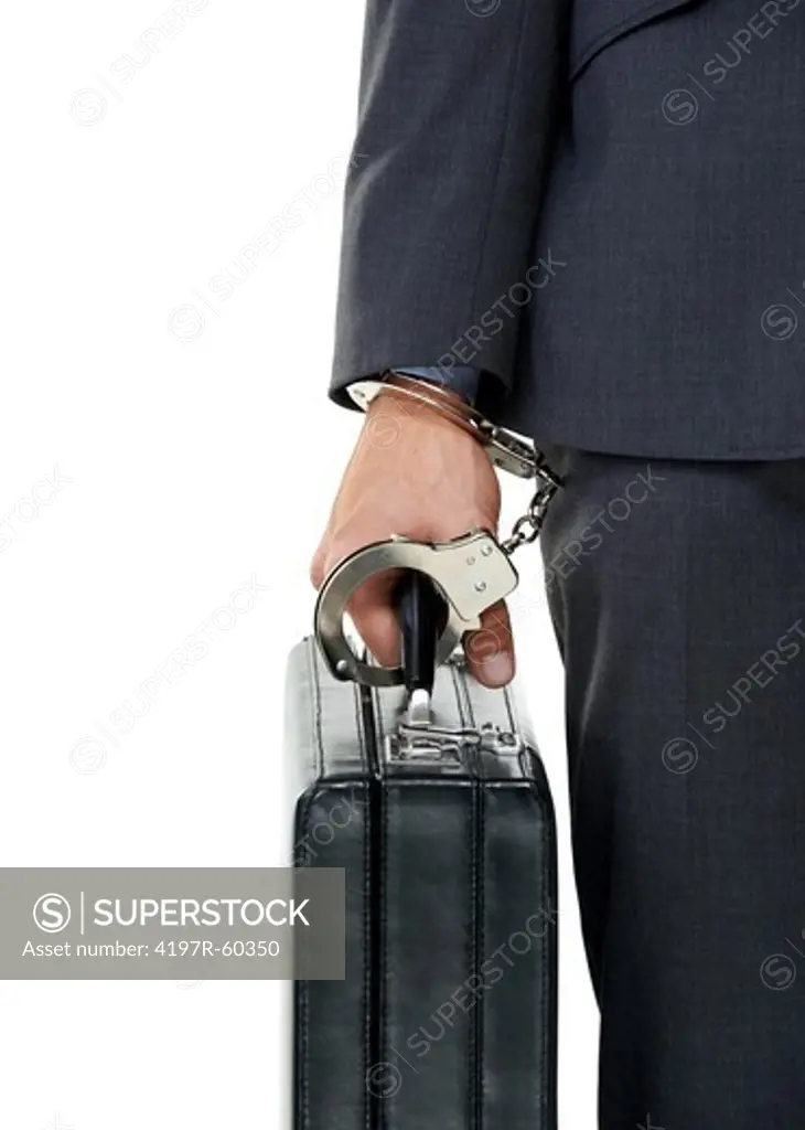 Cropped closeup of a man handcuffed to his briefcase