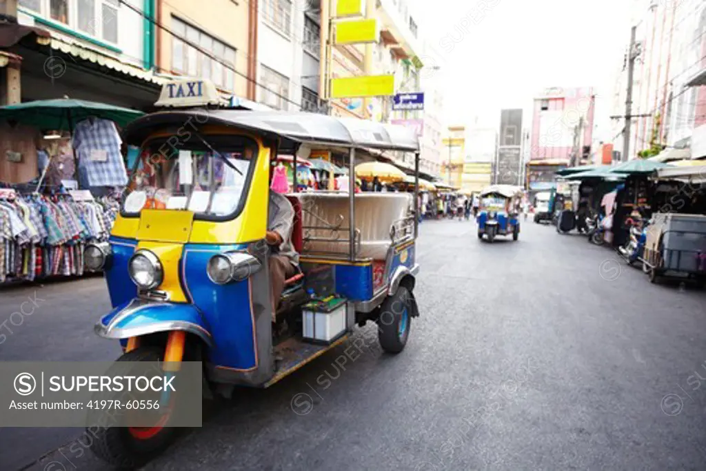 Traditional Thai taxi driving in road - Tuk-Tuk
