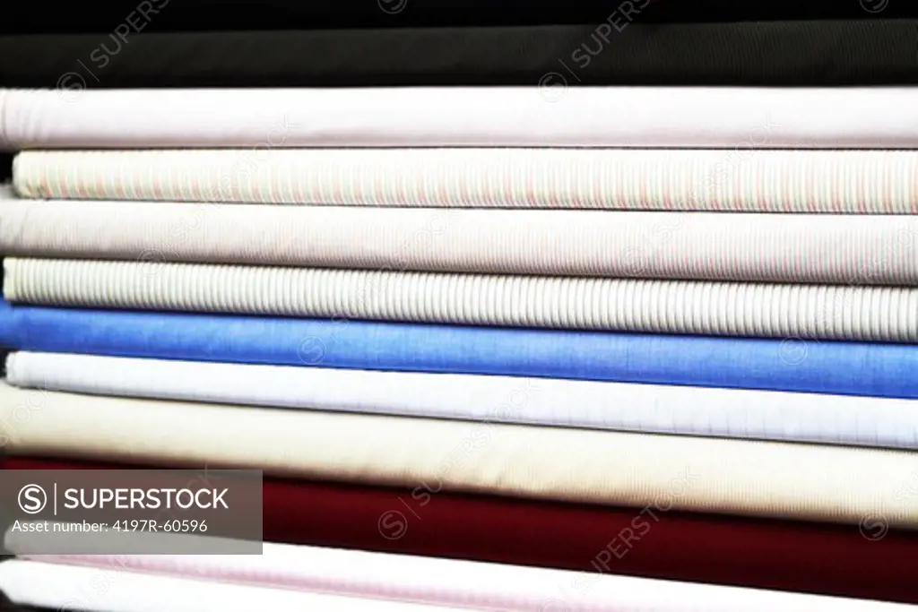 A stack of rolled fabrics at a market stall