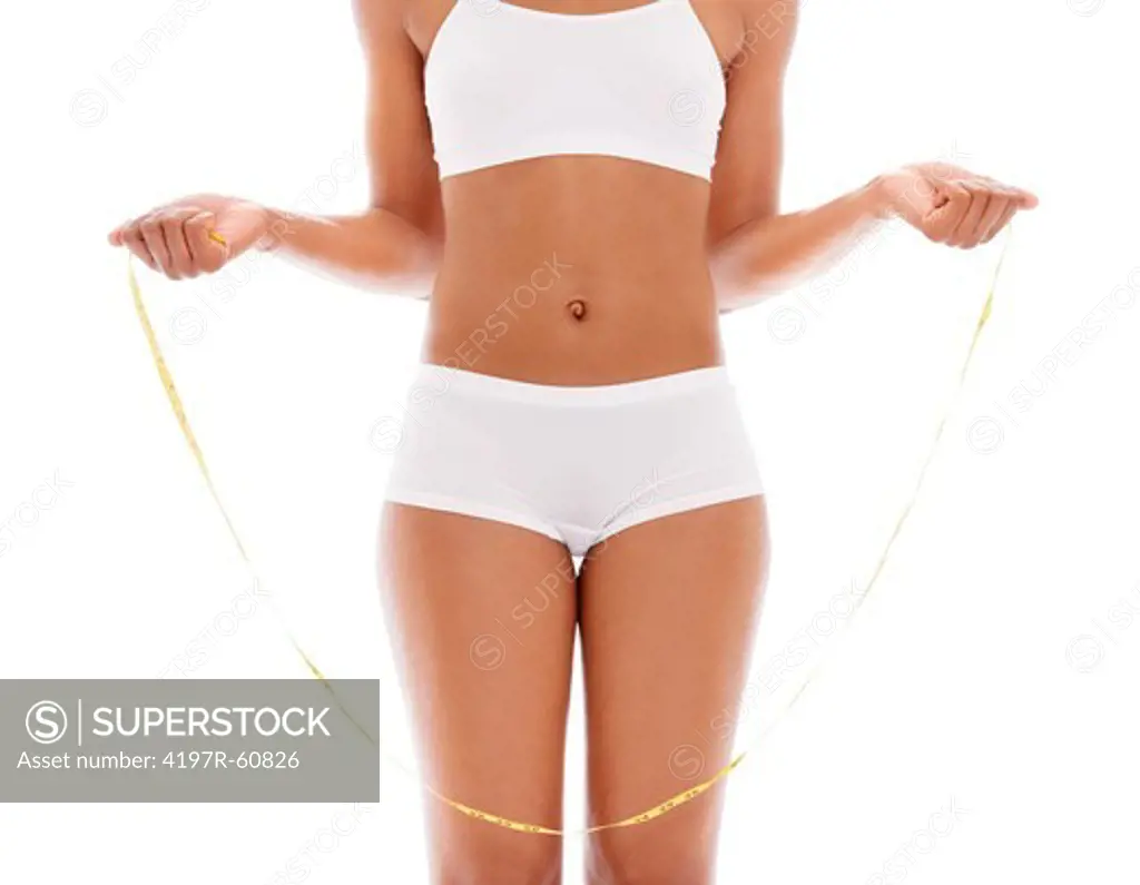 Cropped view of a young woman in her underwear measuring herself