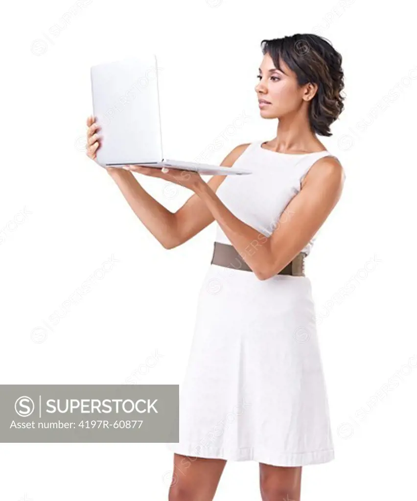 Attractive businesswoman using a laptop while standing against a white background