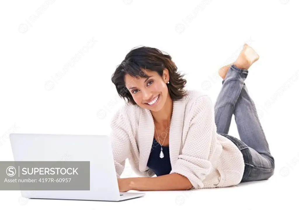Portrait of a young woman lying down and surfing the net