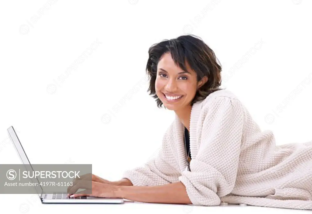 Portrait of a young woman lying down and relaxing with her laptop
