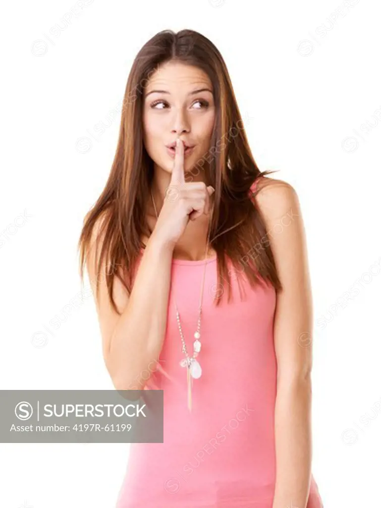 A beautiful young woman with her finger in front of her mouth in a 'quiet' gesture