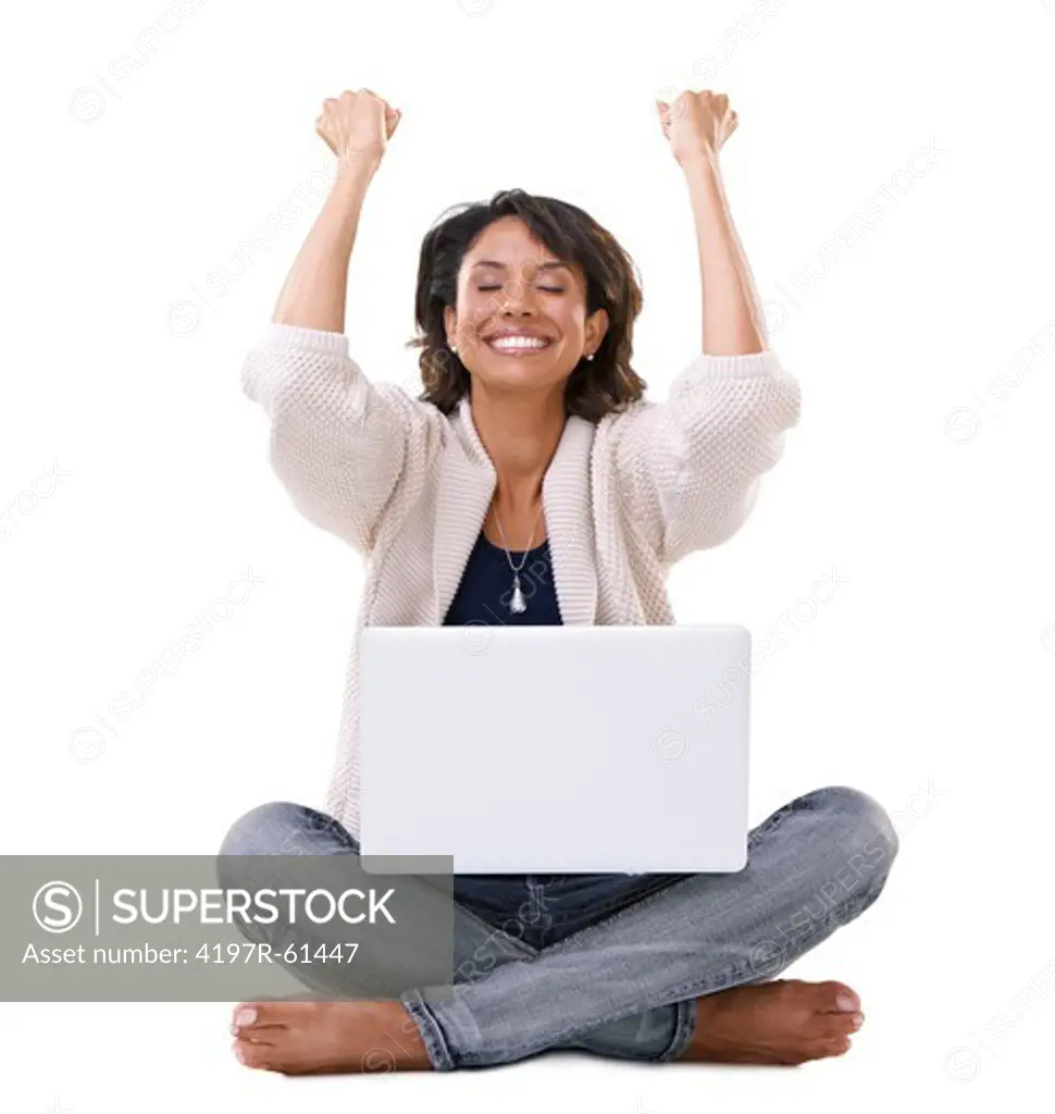 A young woman looking relieved and happy while sitting with her laptop