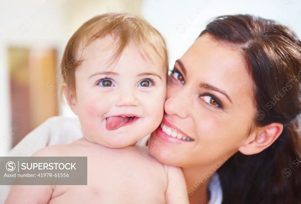 Close up portrait of a smiling mother and baby at home