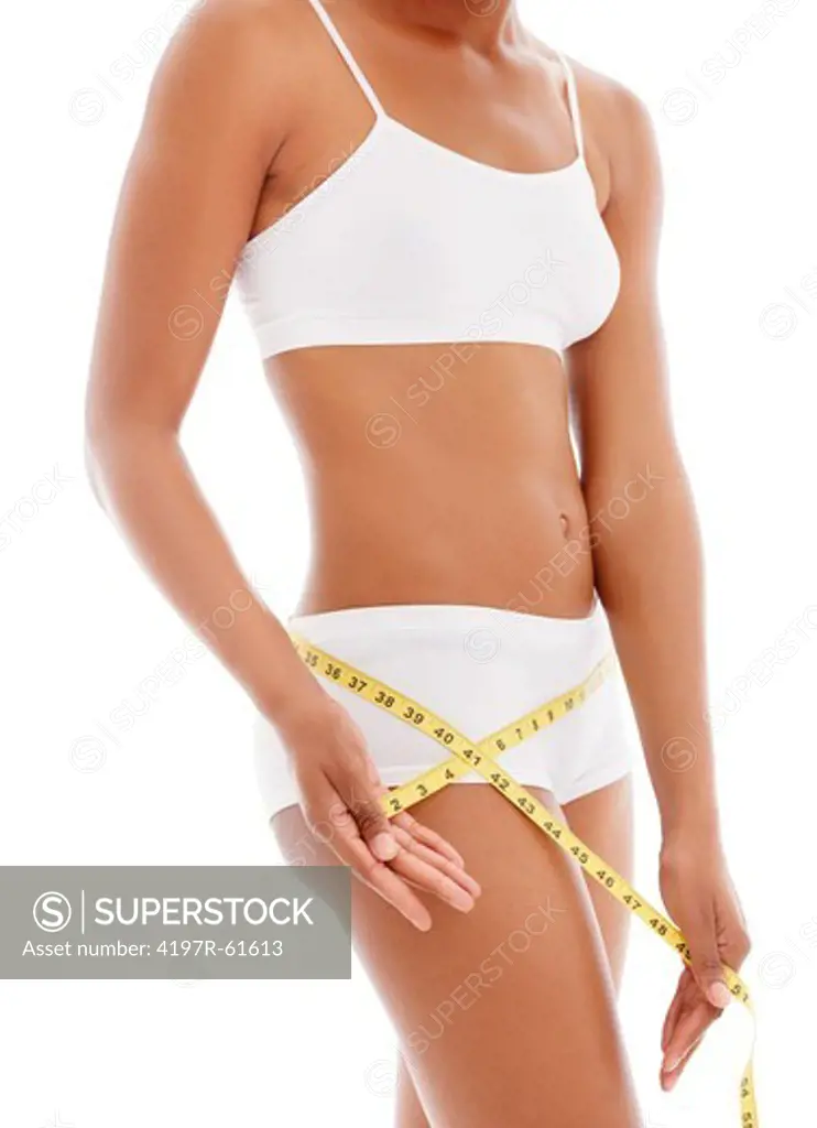 Cropped view of a young woman in her underwear measuring herself