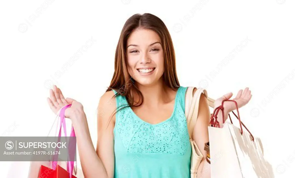 A stunning young woman smiling while holding up her shopping bags