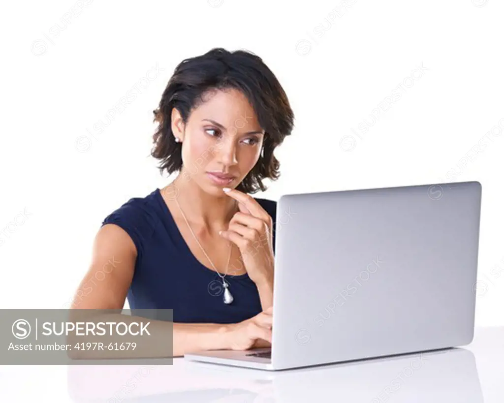 A young woman looking pensive while surfing the net